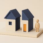 Maquette diorama d'une maison coupee en deux moities separables sur un socle, credit immobilier paye seul apres separation